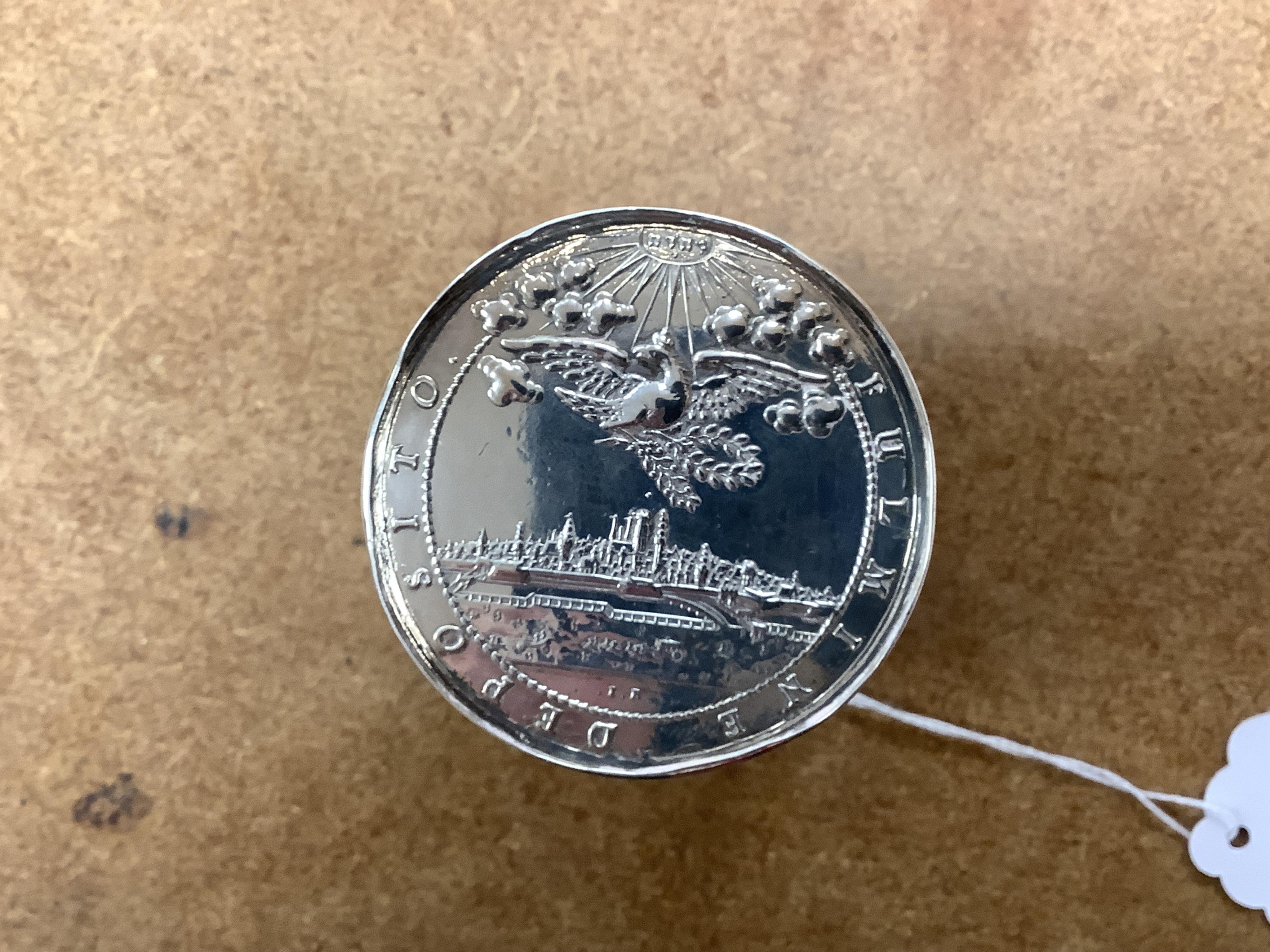 A white metal beaker the base inset with a silver medal commemorating the Peace of Oliva, 1660, Obv. Bird's-eye view of the city of Danzig with troops moving in foreground; above, an eagle crowned, an olive branch in its